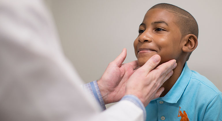 Image of doctor examining child